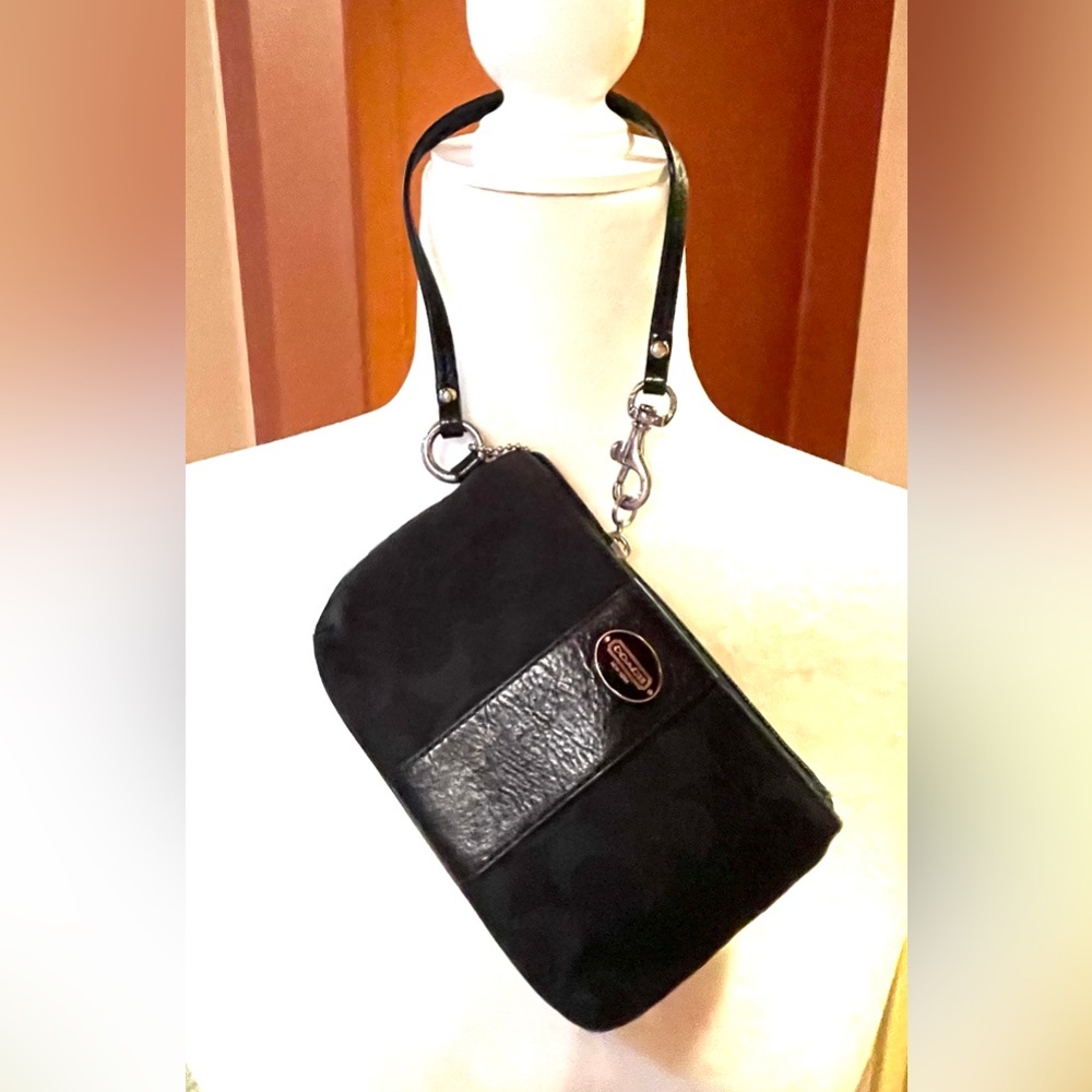Pre-owned-black canvas and leather Coach mini wristlet.